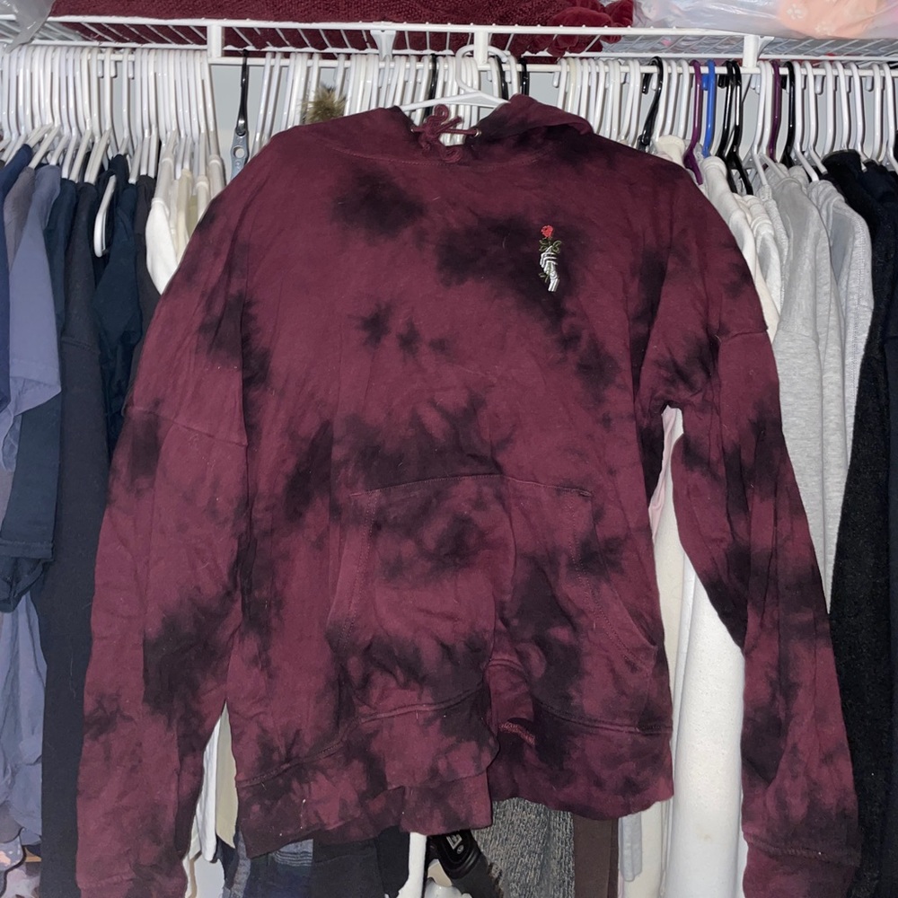 tye-dye sweatshirt with skeleton hand holding rose detail